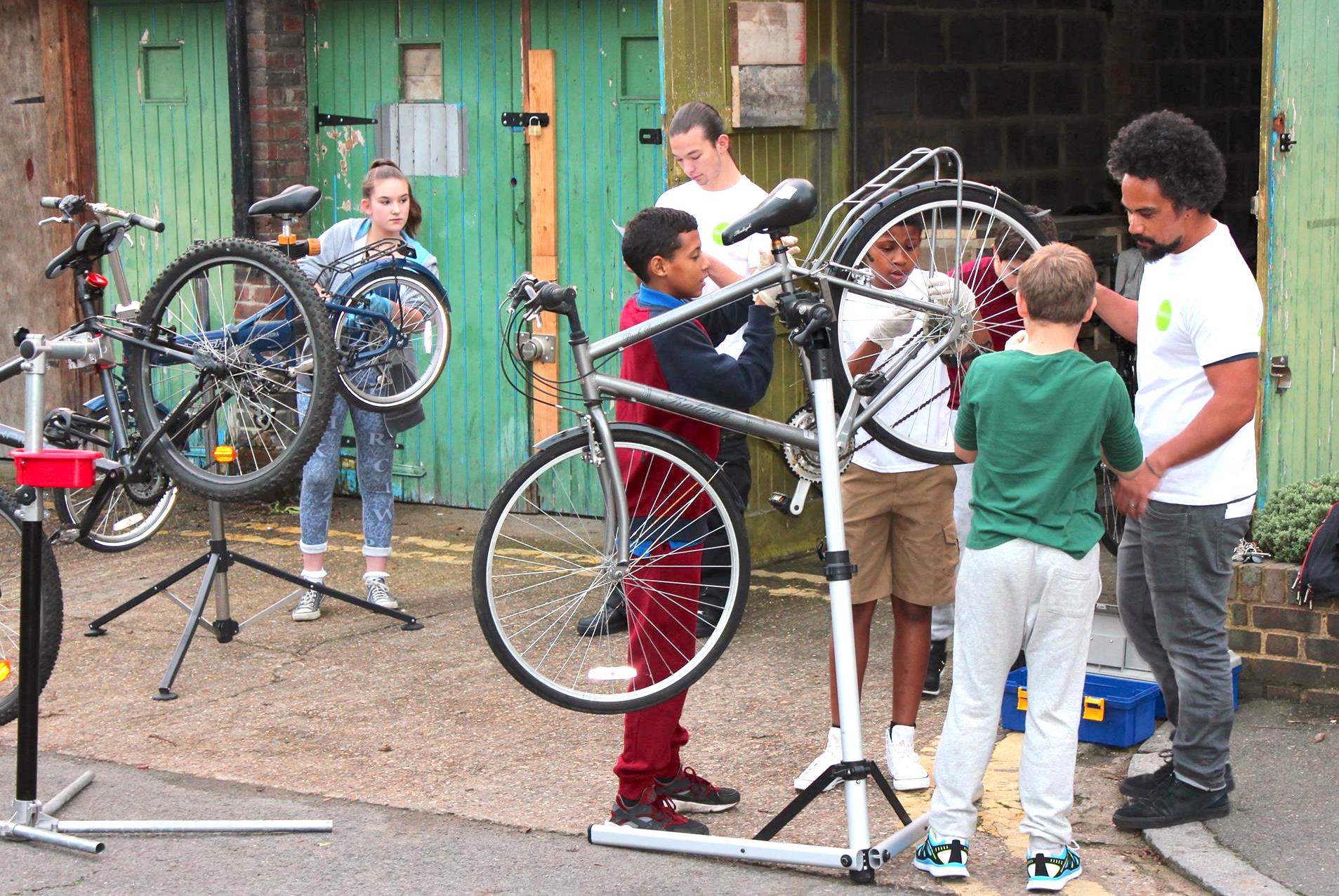 Young people learning how to fix bikes