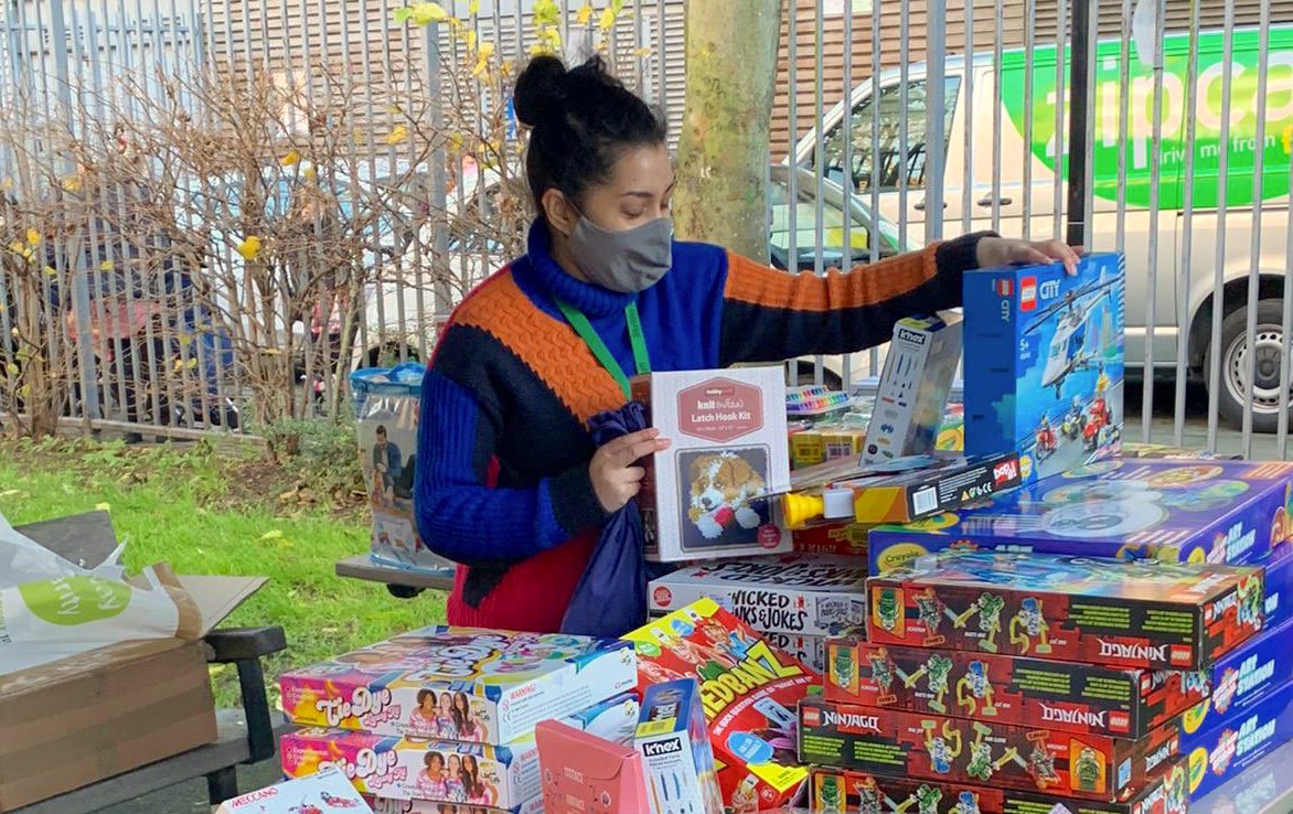 Volunteer organising Christmas present packages at SkyWay