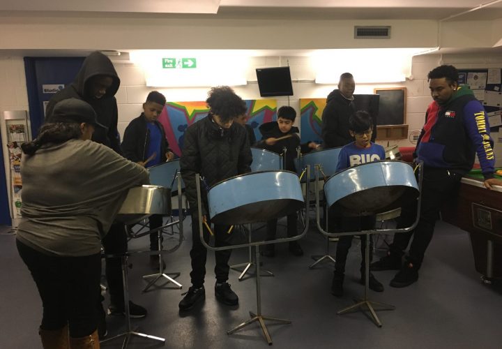 young people playing on steel pans