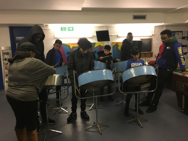 young people playing on steel pans