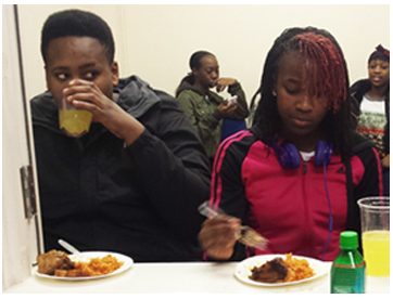 Young people eating jolloff rice