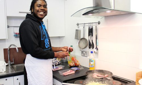 Smiling young person in kitchen