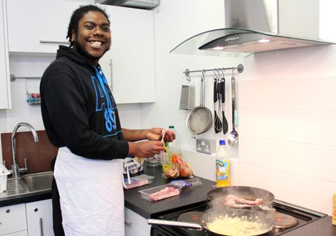 Young person smiling in the new Blue Hut kitchen