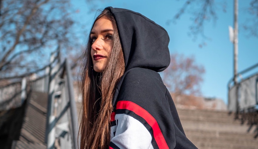 Young woman looking up outside