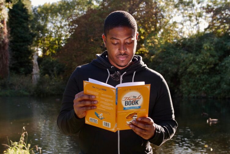 Teenager reading outdoors in nature